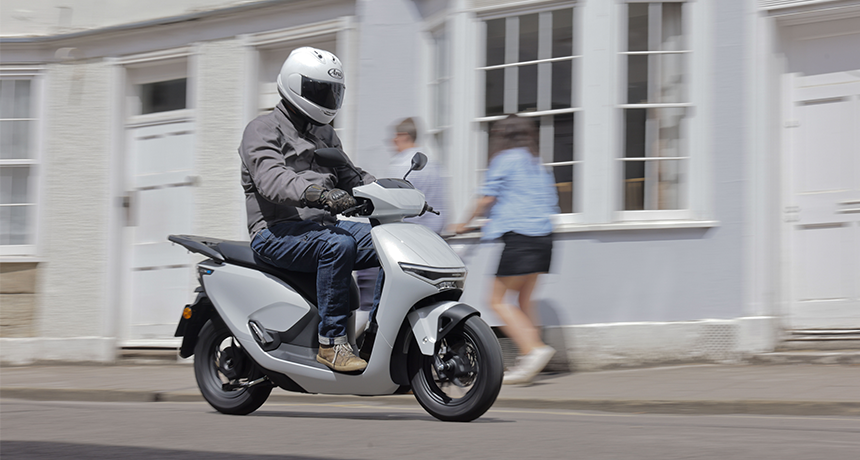 Person rides Honda CUVe: along a street