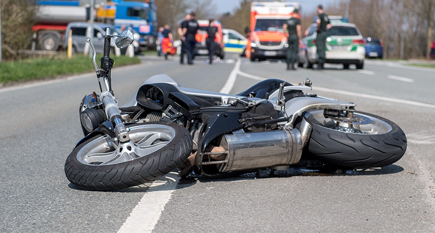 Crashed motorcycle near emergency vehicles