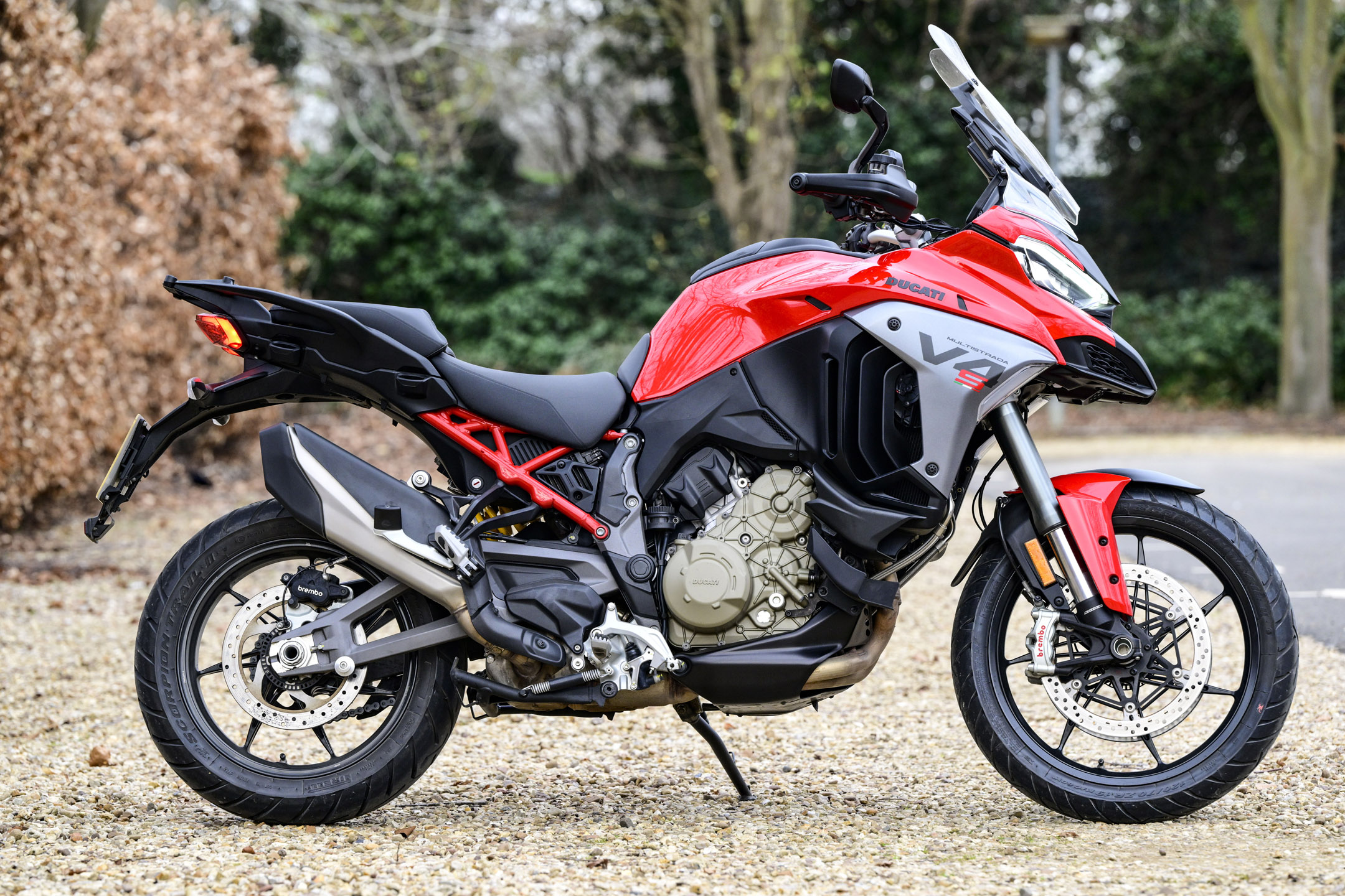 The red/grey/black Ducati Multistrada adventure bike parked in a stone car park
