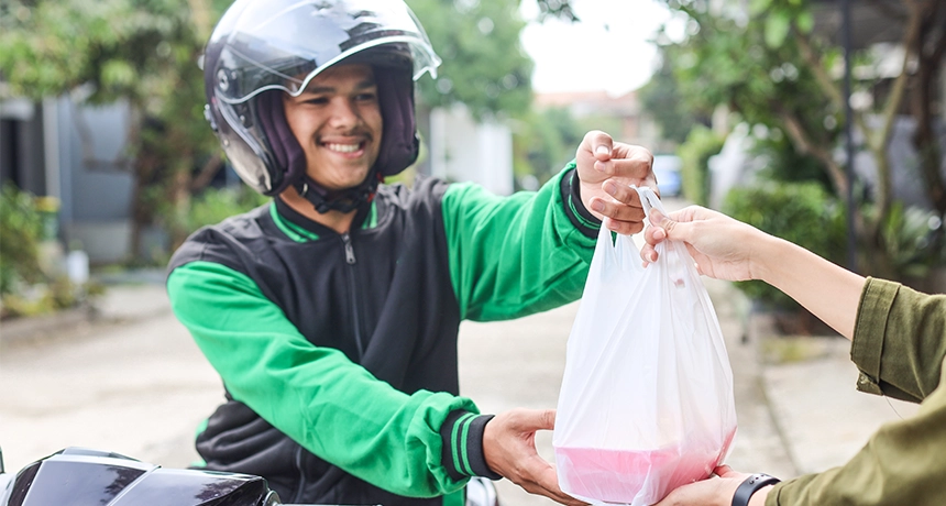 delivery rider handing over food