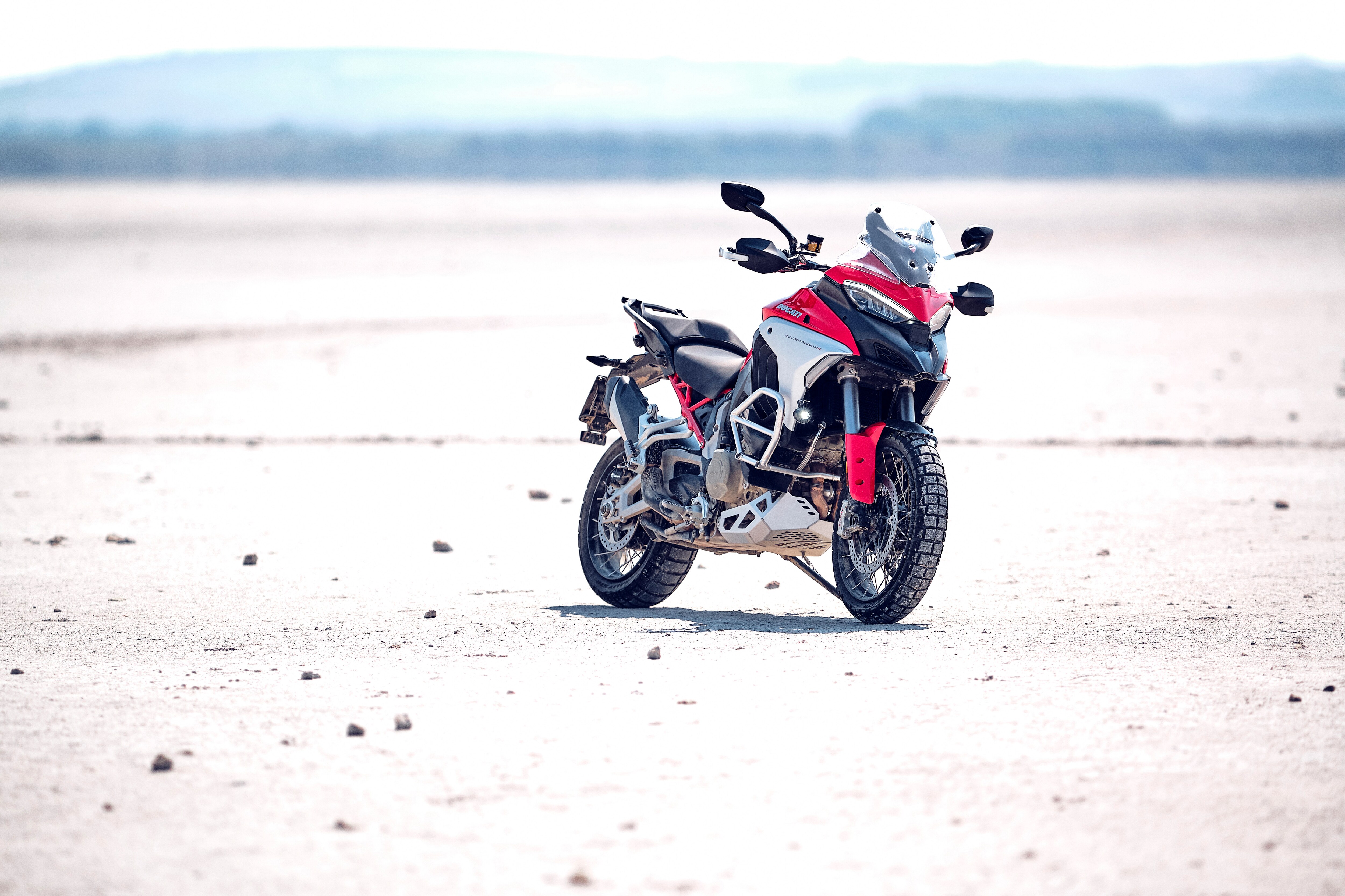 Ducati Multistrada in iconic red somewhere in an arid plain