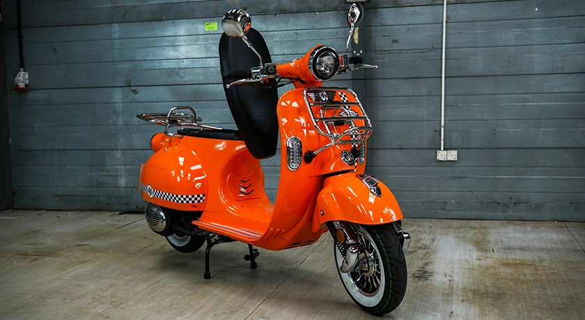 AJS Modena in a motorcycle studio.webp