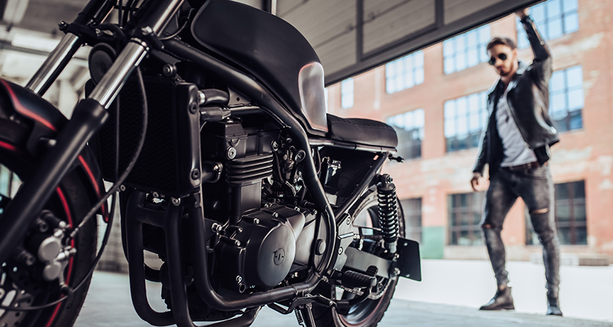 man with motorbike in garage