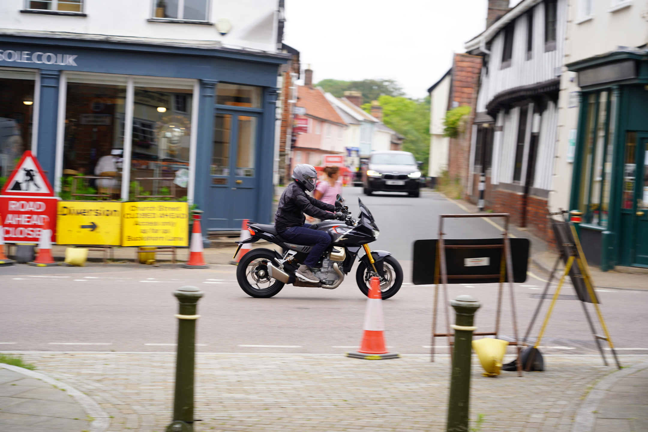 Riding in an English town on the Moto Guzzi V100 Mandello S