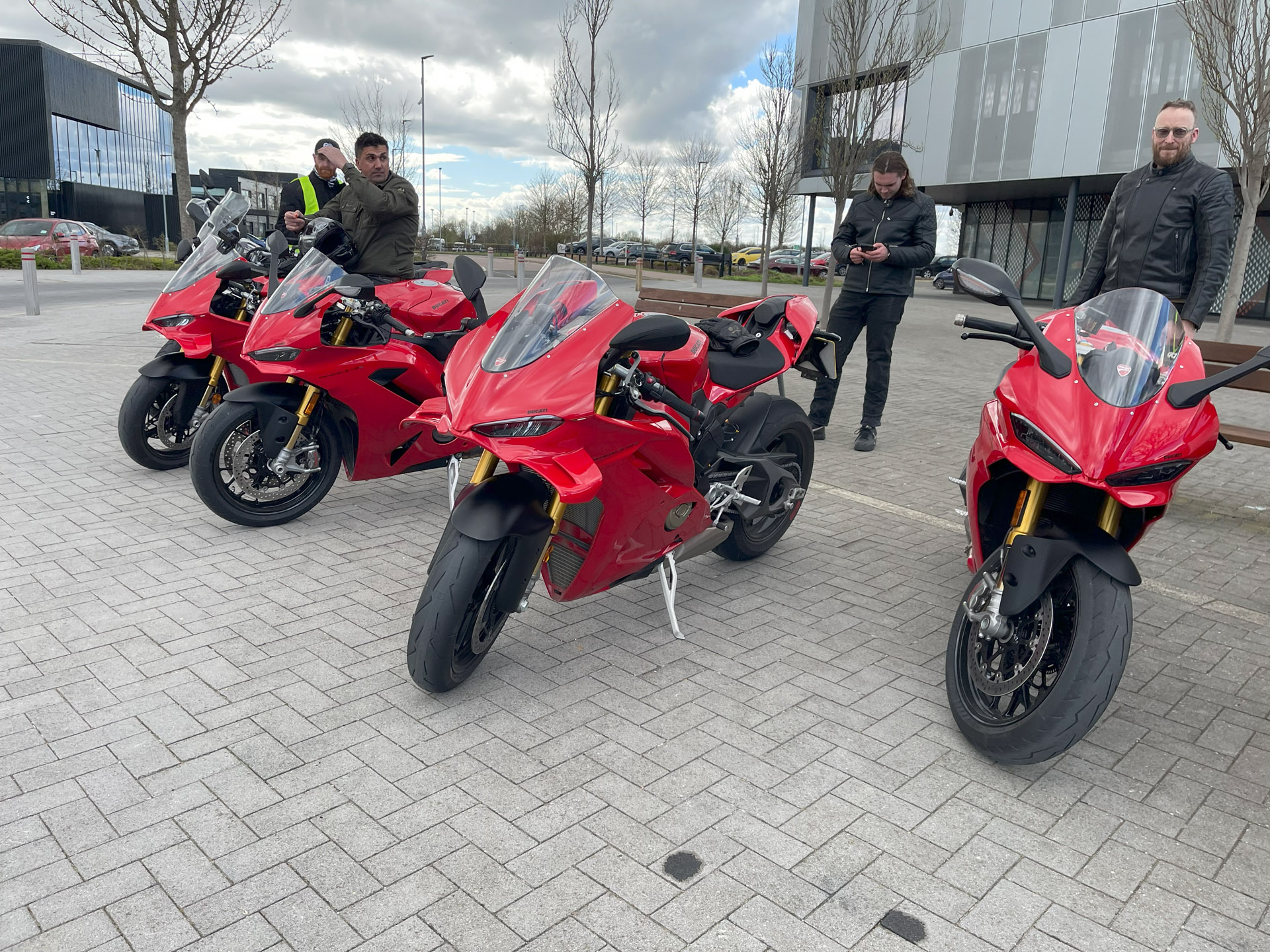 Four red Ducati sports bikes parked in a Business Park Car Park in Peterborough