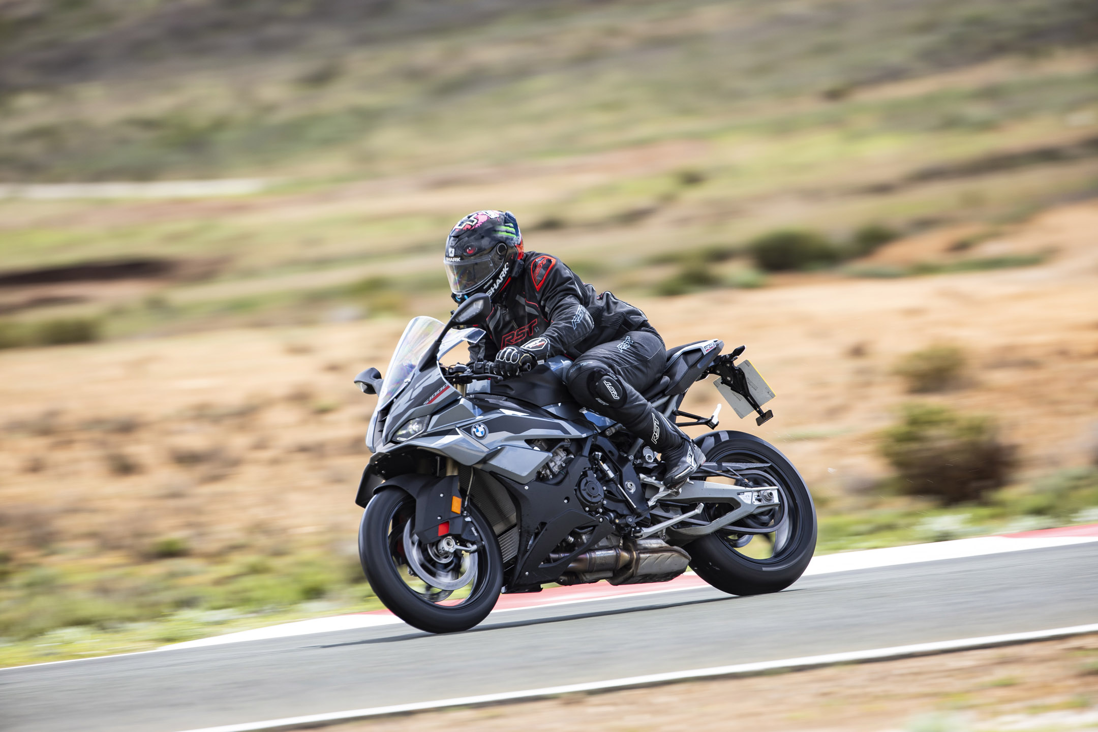 Young man riding a BMW Sport styled bike on a race track in Spain