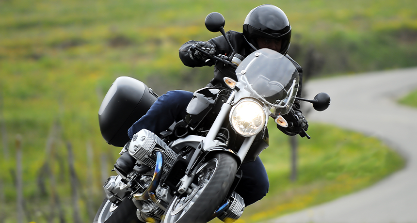 person turning corner on motorbike.png