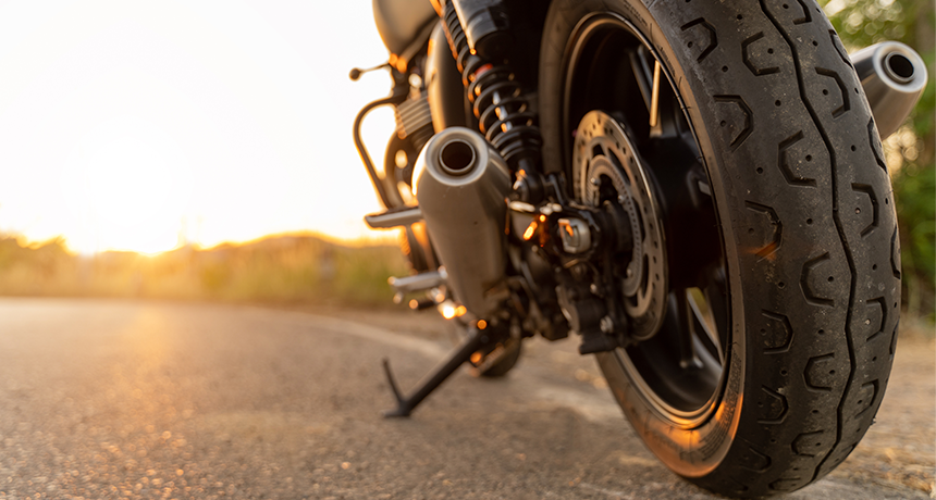 motorbike wheel on road at sunset