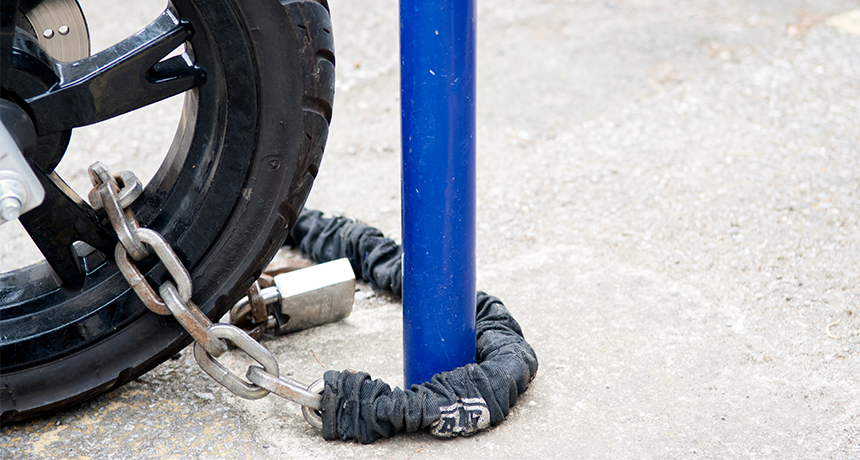motorbike locked with a chain to prevent theft