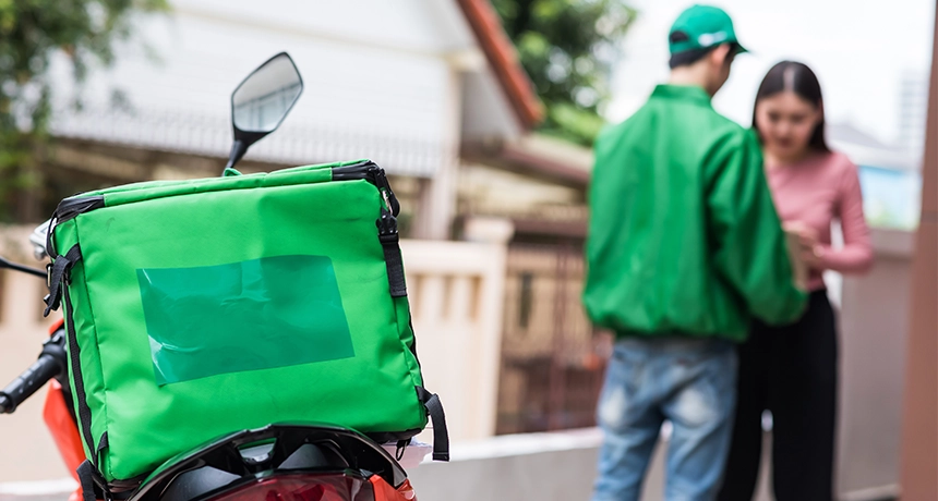 Delivery rider giving person food