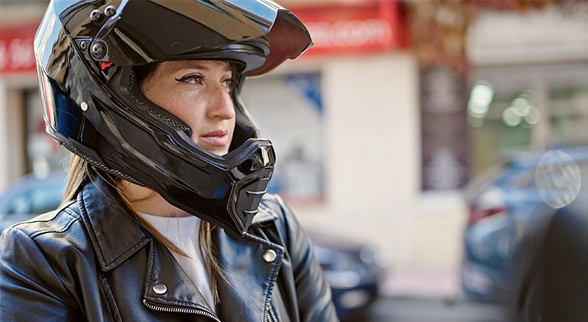 woman with a motorcycle helmet.webp