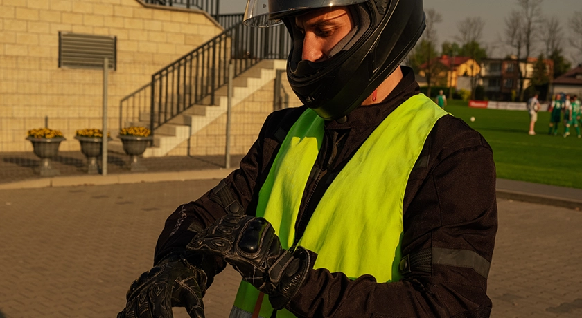 learner rider puttong on his motorcycle gear.webp