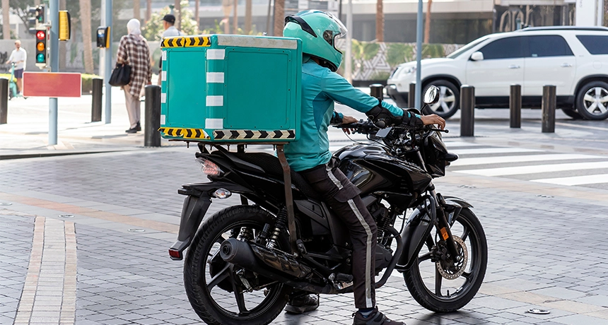 Delivery rider stops on motorbike