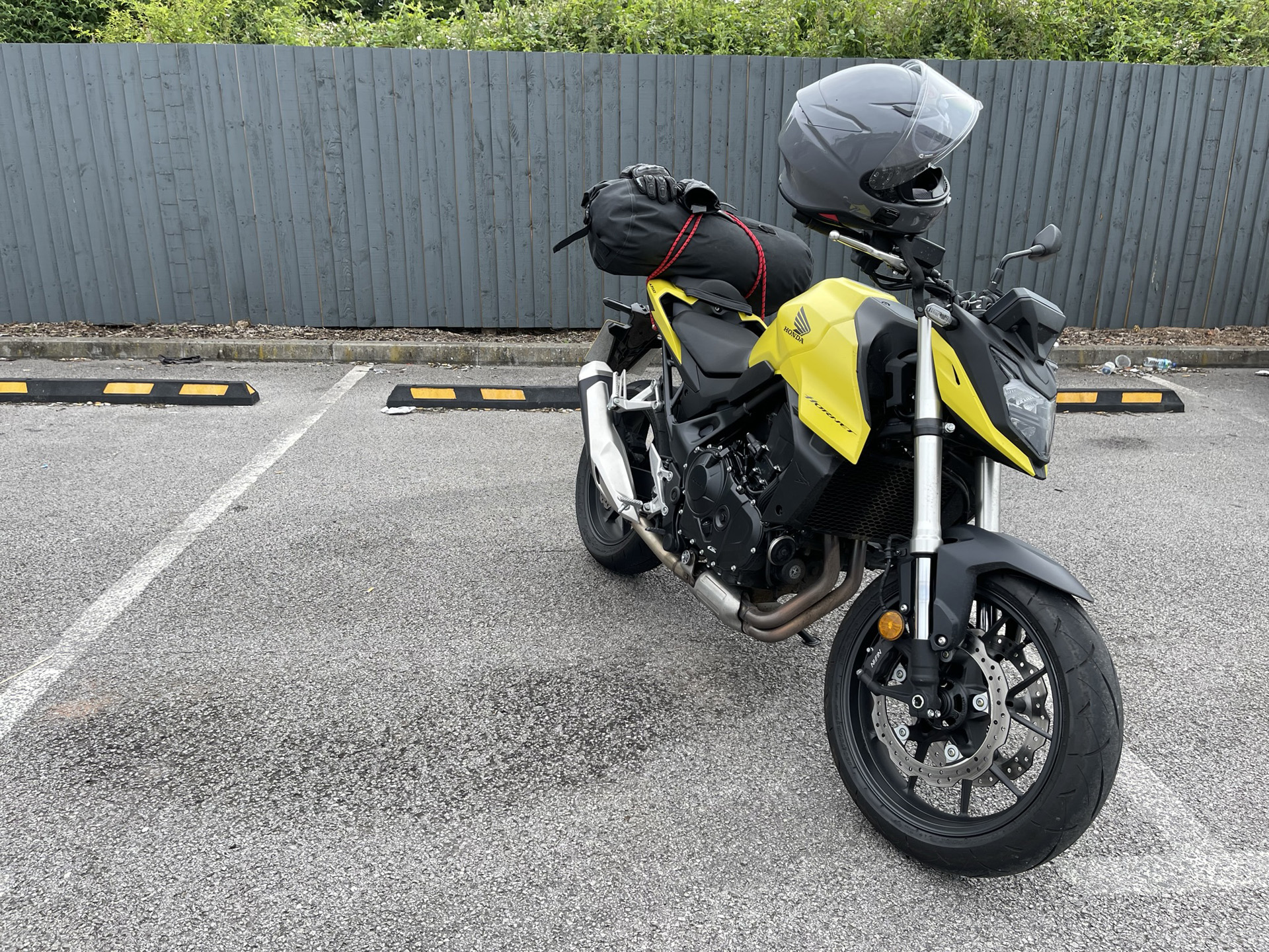 Honda with roll-top bag and motorcycle helmet