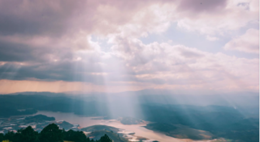 Beams of sunlight shining through clouds