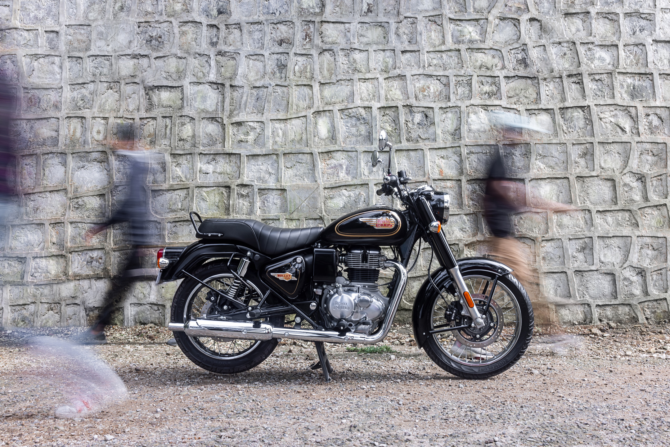 Royal Enfield Bullet 350 with people walking behind